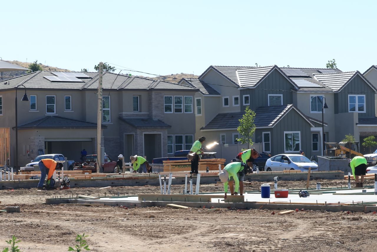 home-services-03 Construction workers laying foundations in a modern housing development.